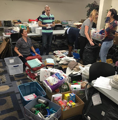 4 volunteers in  the picture are sorting out the donations items